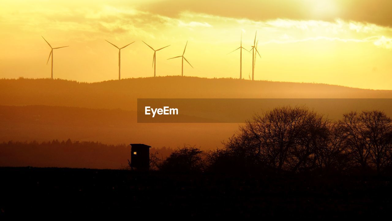 Wind turbines on the hill during sunset