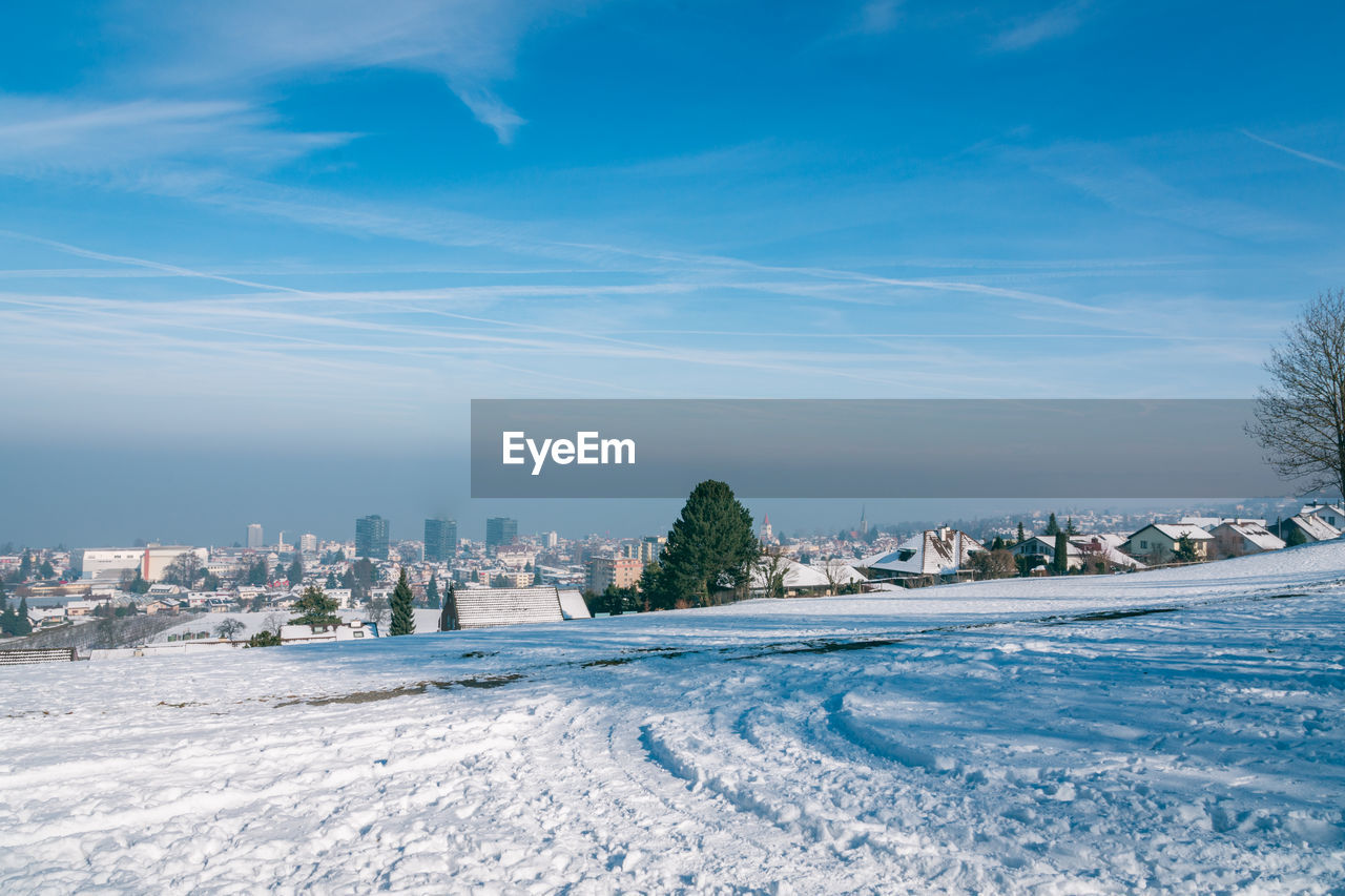 CITY BUILDINGS AGAINST SKY DURING WINTER