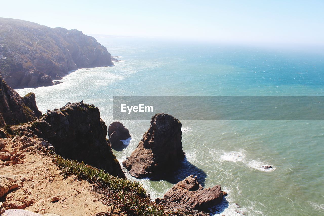 High angle view of rock formation in sea against sky