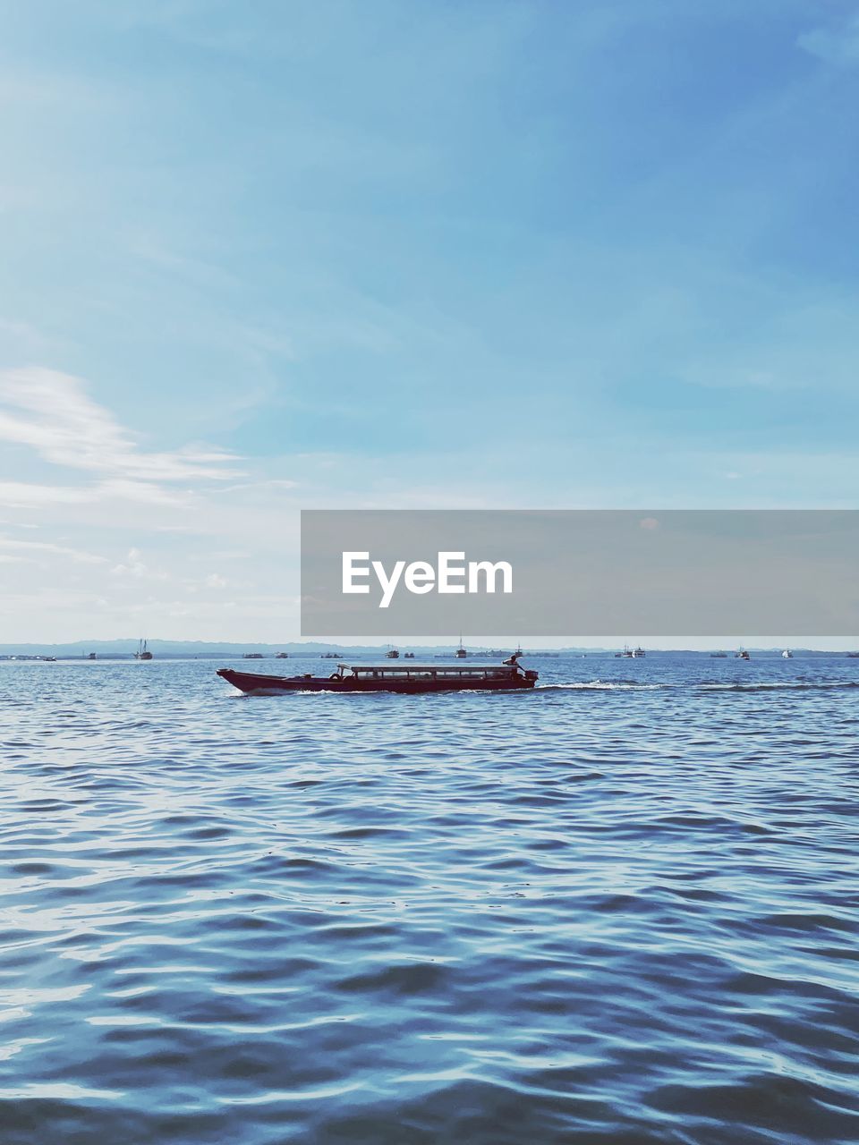 Boat sailing in sea against sky