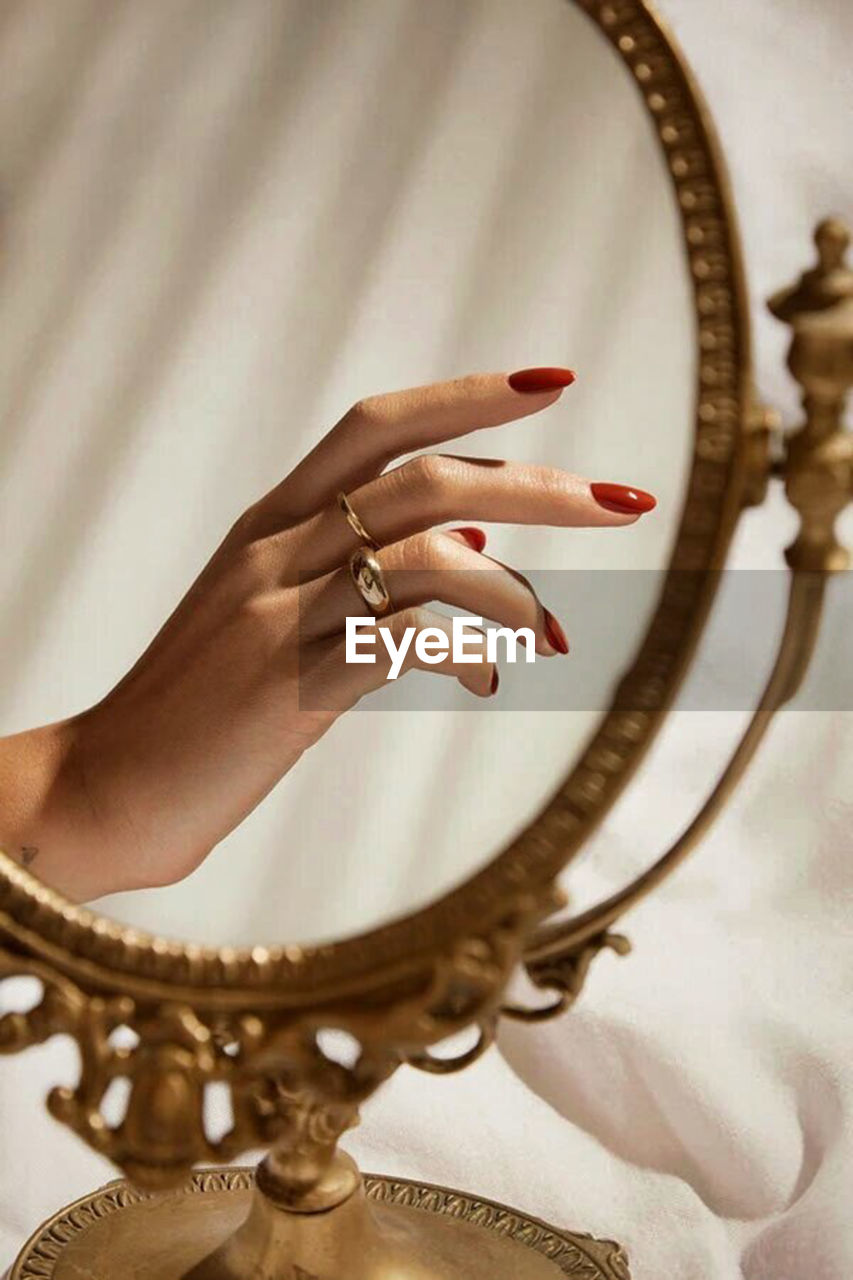 one person, adult, hand, brown, women, jewelry, indoors, fashion, ring, jewellery, wealth, close-up, nail, studio shot, luxury, nail polish, fashion accessory, arts culture and entertainment