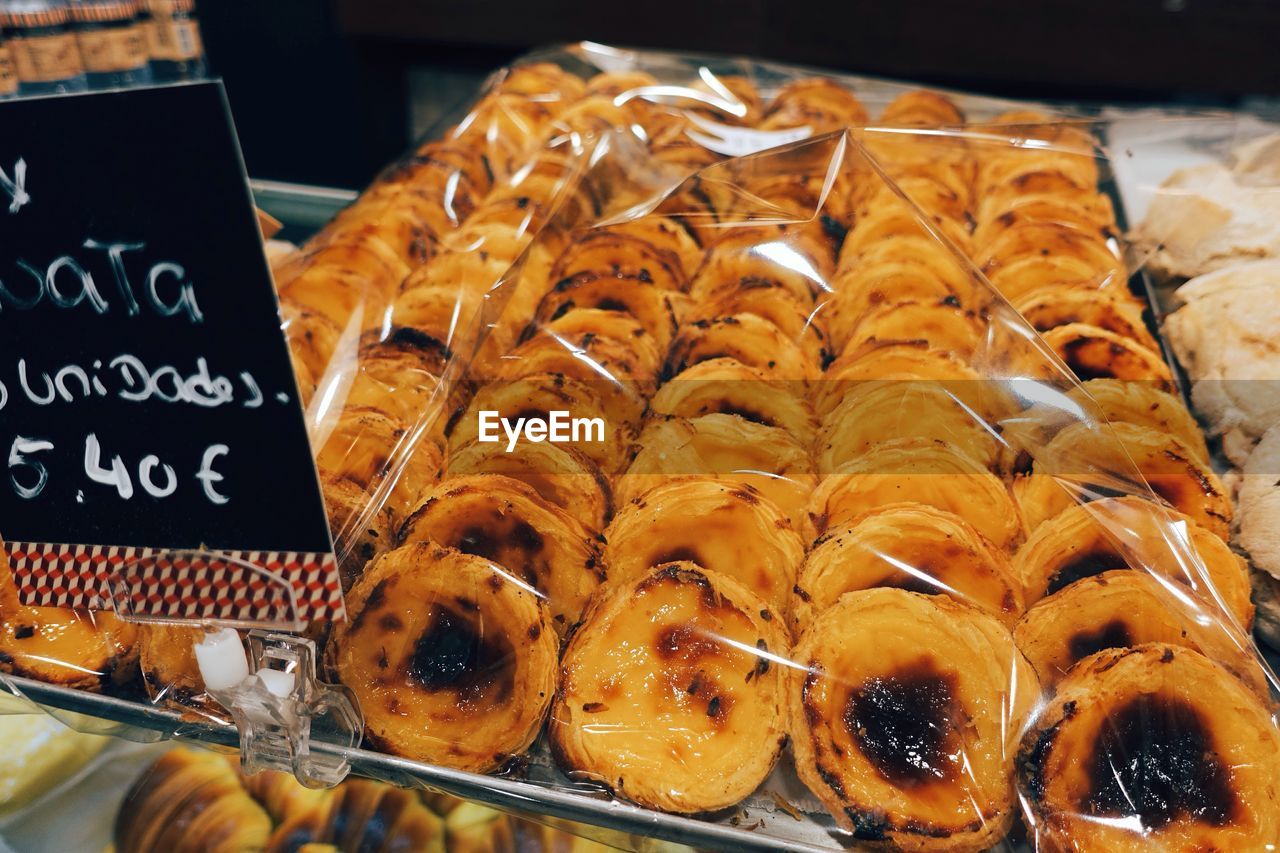 Close-up of sweet food in plastic on display cabinet at store