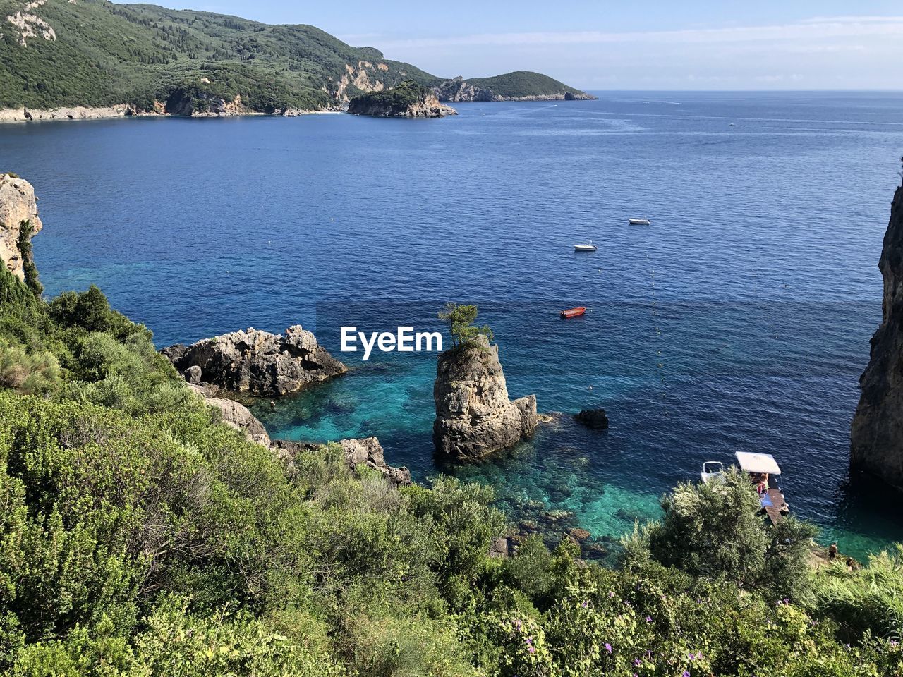 High angle view of rocks by sea against sky