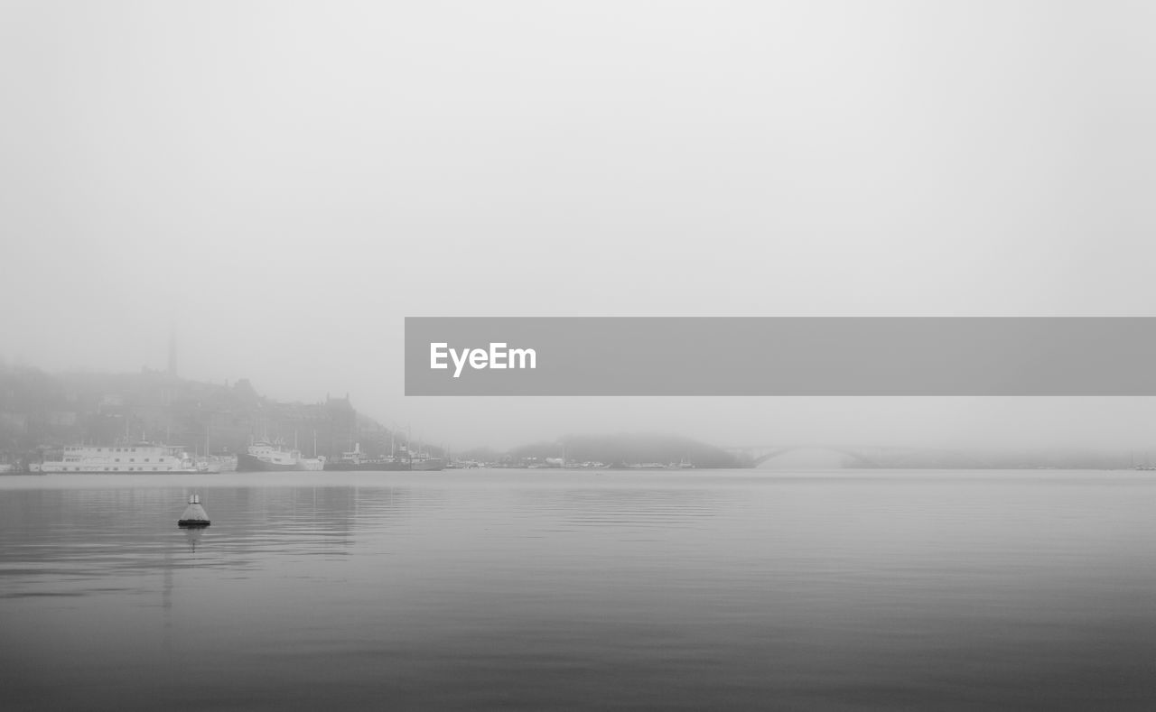 Scenic view of lake against sky during winter