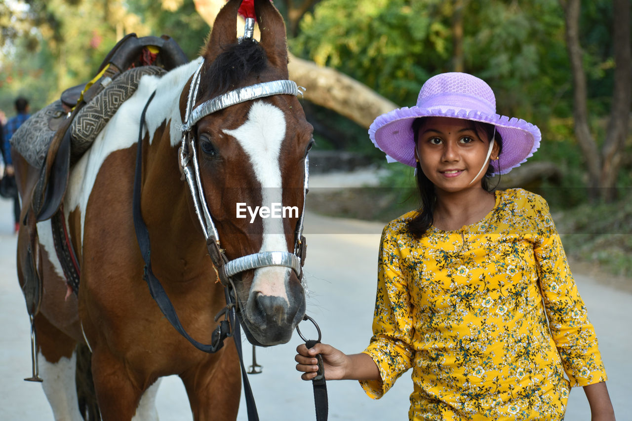 A teenage girl working with a horse