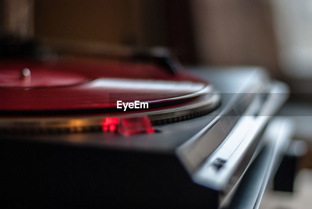 Close-up of red record playing in turntable