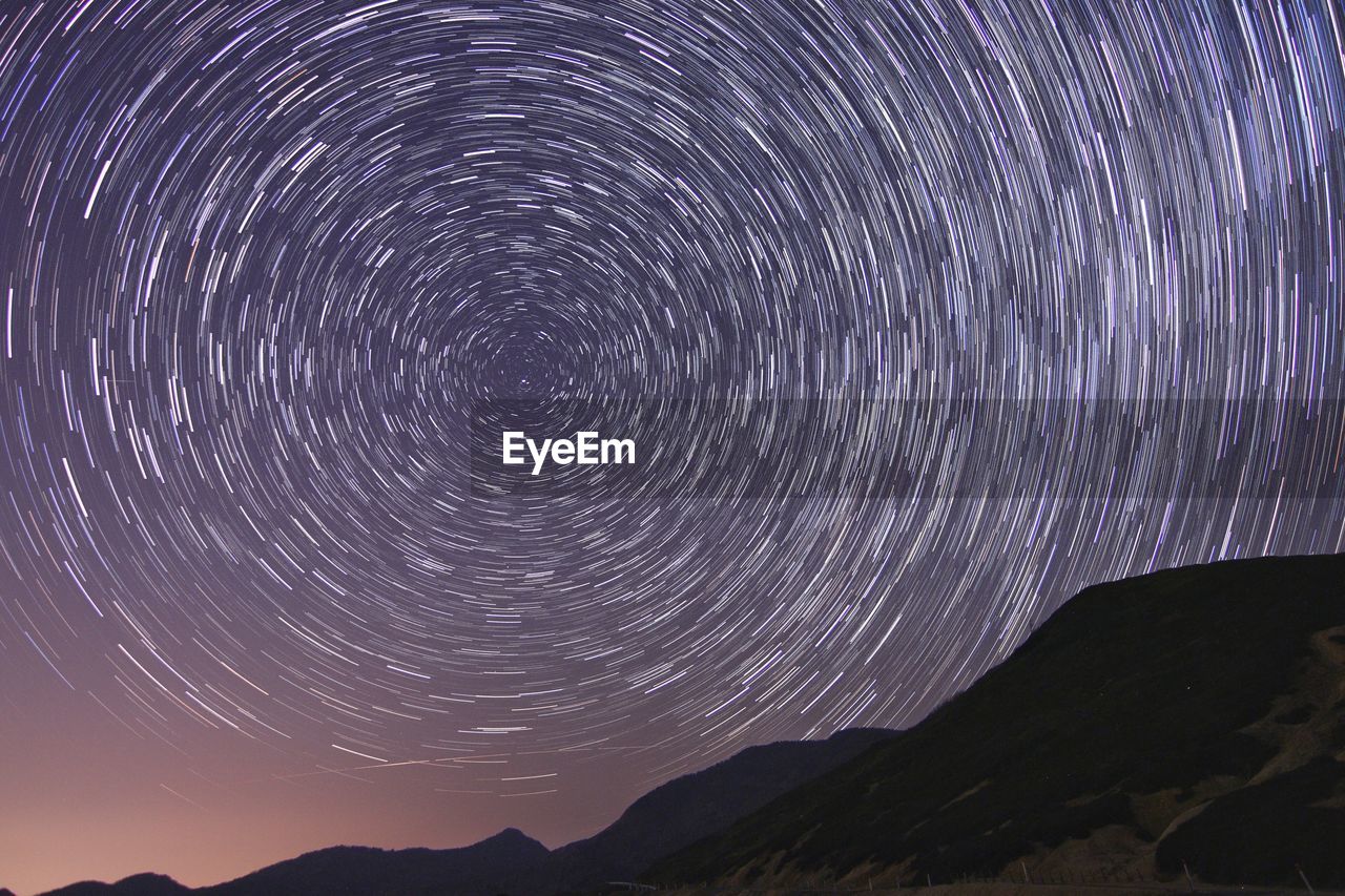 Scenic view of mountains against sky at night