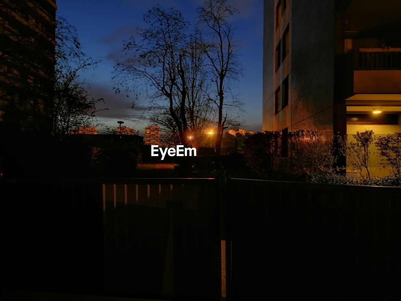 ILLUMINATED BUILDING AGAINST SKY AT SUNSET