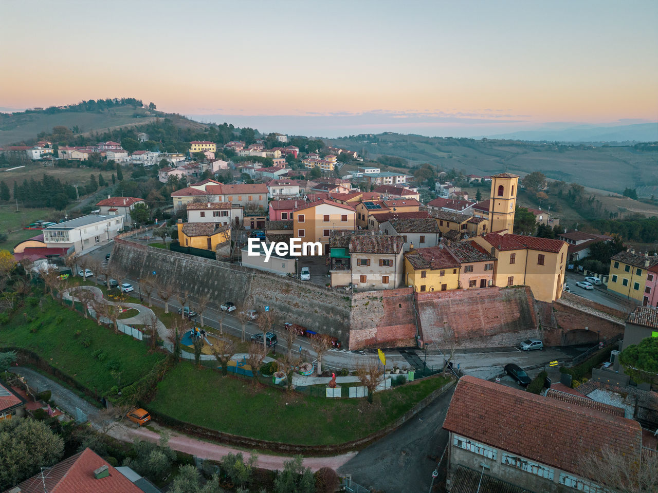 architecture, building exterior, built structure, city, town, building, high angle view, cityscape, sky, aerial photography, sunset, nature, residential district, travel destinations, bird's-eye view, landscape, travel, history, the past, roof, house, aerial view, environment, no people, outdoors, tourism, land, old, scenics - nature, street, dusk, urban area, religion, horizon, urban skyline, clear sky, ancient, hill