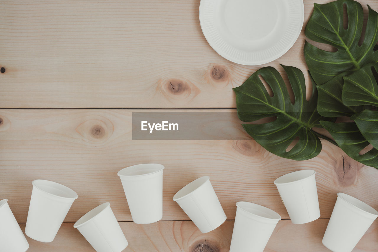 HIGH ANGLE VIEW OF COFFEE CUP ON WHITE TABLE