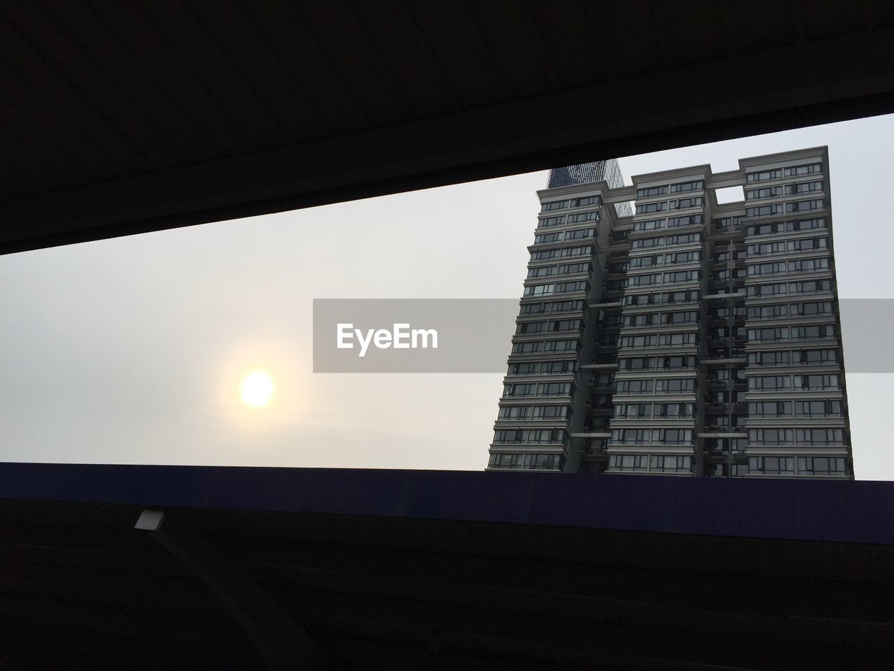 LOW ANGLE VIEW OF BUILDINGS AT SUNSET