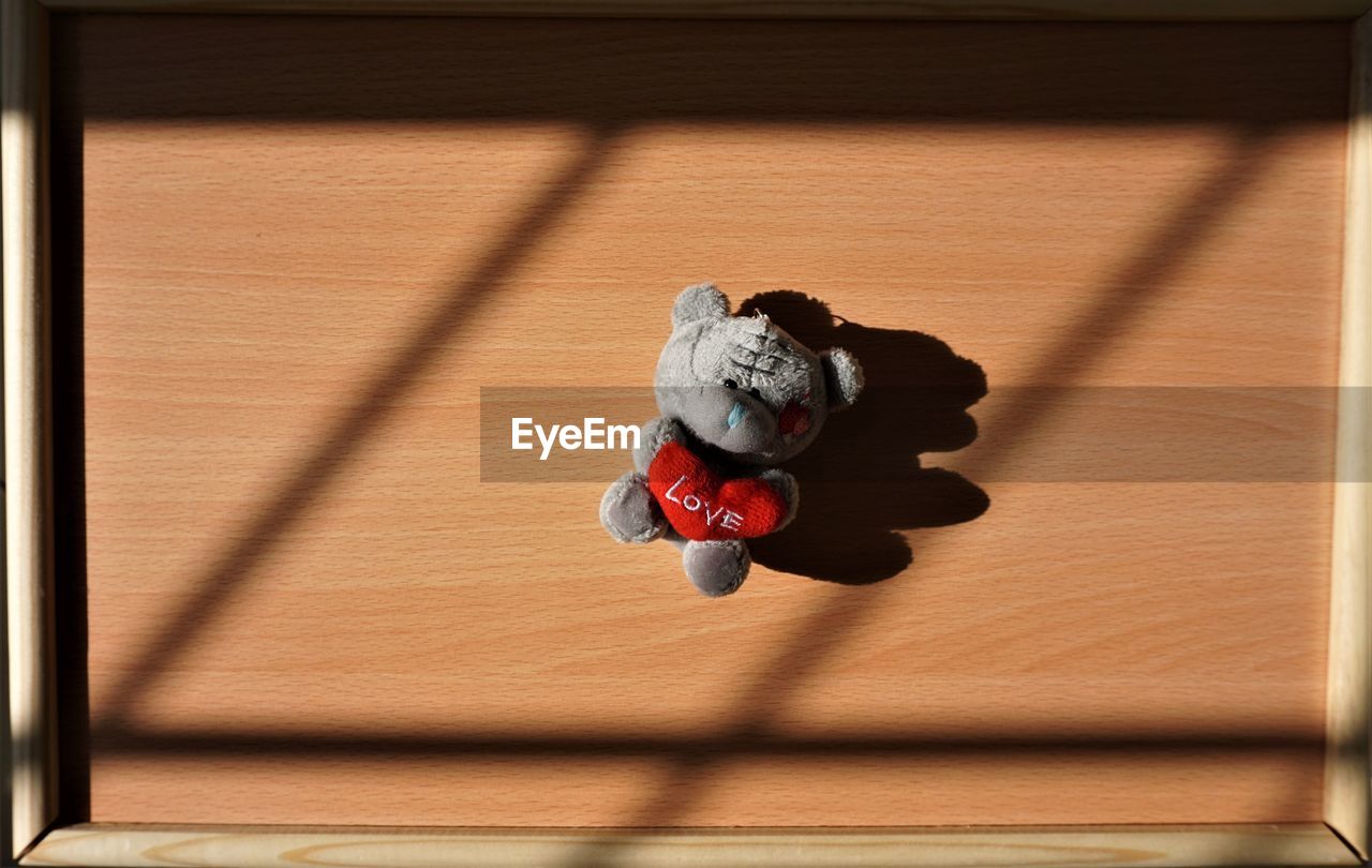 CLOSE-UP OF TOY ON WOODEN FLOOR