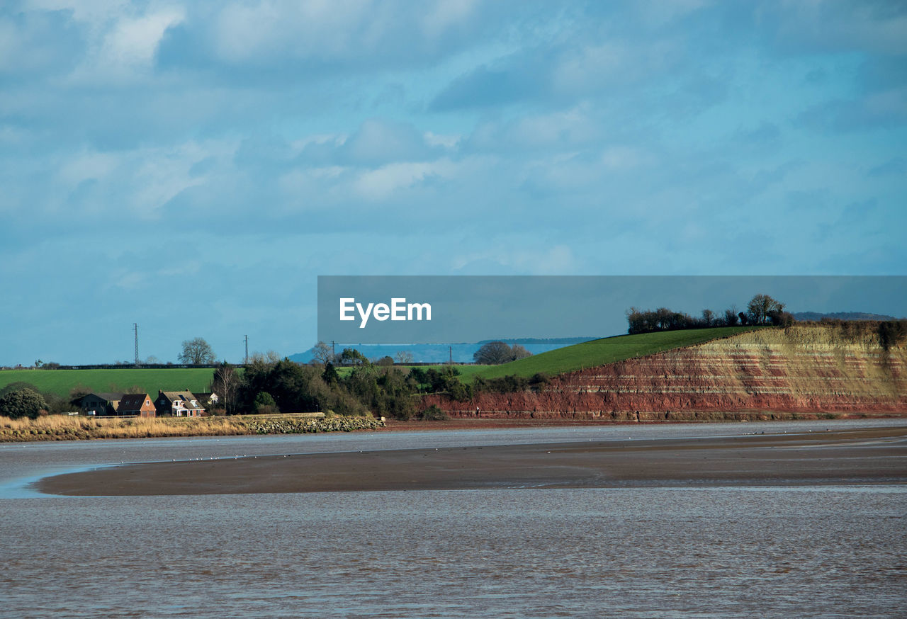 Scenic view of river severn against cloudy sky