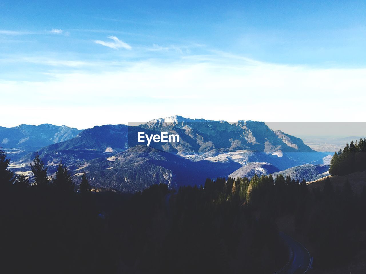 Scenic view of mountains against cloudy sky