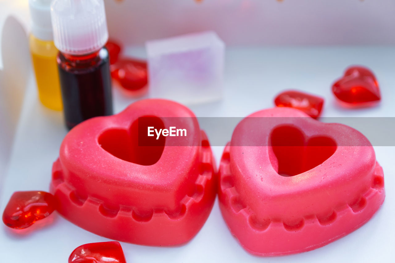 pink, heart, red, lip, love, heart shape, positive emotion, valentine's day, no people, indoors, healthcare and medicine, food and drink, emotion, close-up, container, bottle, studio shot, food, group of objects, sweet food, sweet