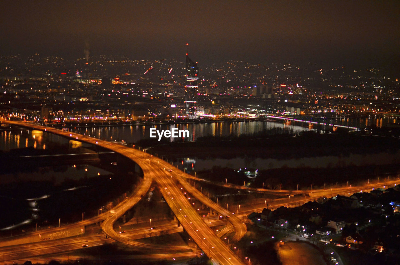 High angle view of illuminated roads in city at night