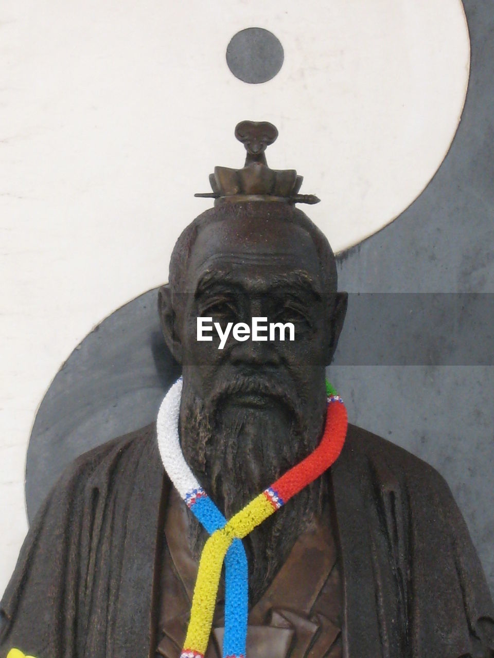 Confucius statue against wall