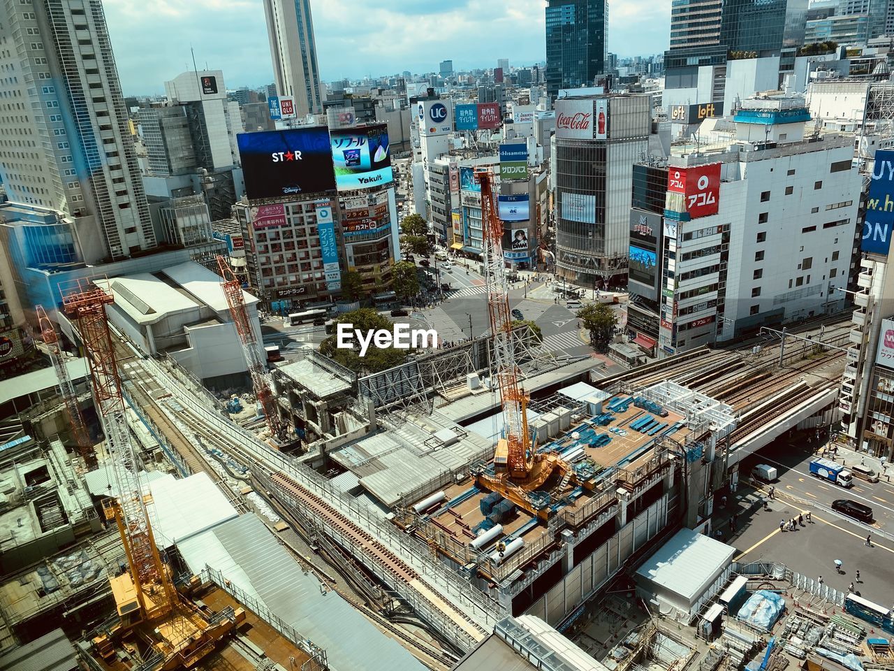 architecture, city, building exterior, built structure, metropolis, metropolitan area, urban area, cityscape, building, office building exterior, skyscraper, high angle view, transportation, skyline, downtown, aerial photography, sky, residential district, urban skyline, landscape, road, street, neighbourhood, city life, no people, residential area, mode of transportation, tower block, travel destinations, day, development, city street, outdoors, nature, office, motor vehicle, traffic, aerial view, tower, car, landmark, travel, downtown district