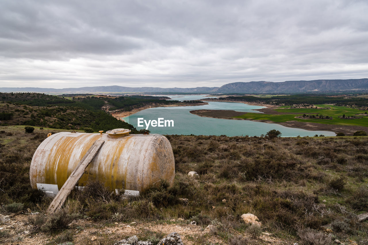 Fiberglass water tank and reservoir with turquoise waters in spring on background. 