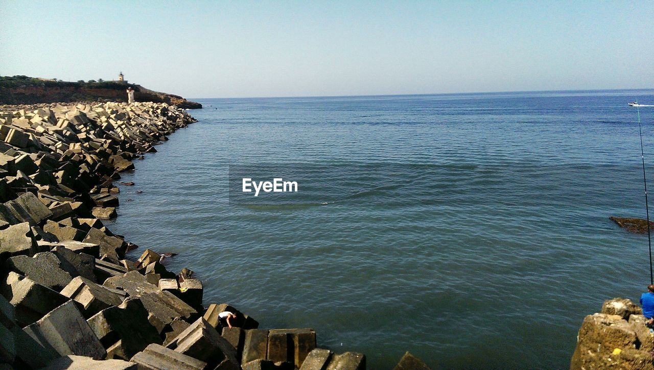 Scenic view of sea against clear blue sky