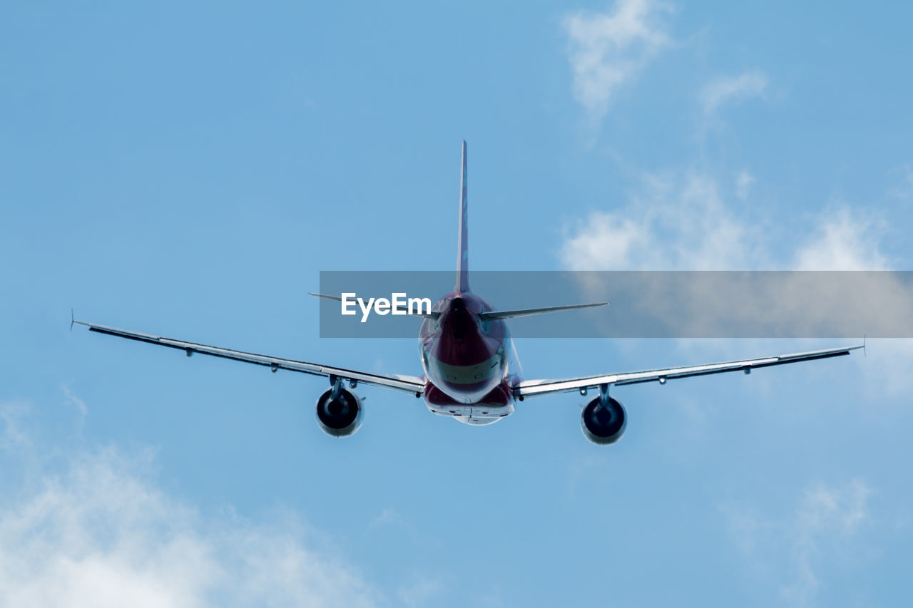 Low angle view of airplane against sky on sunny day