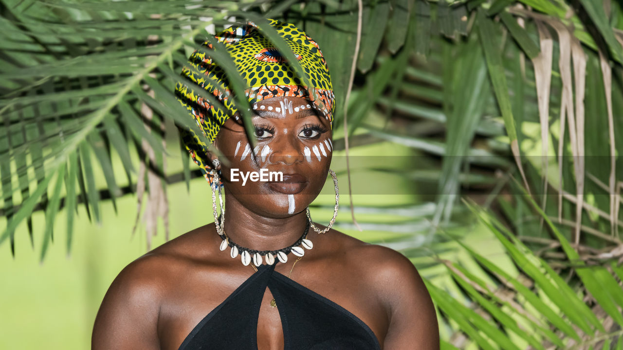 African woman in the jungle with natural evening sun in the tropical part of aburi ghana west africa