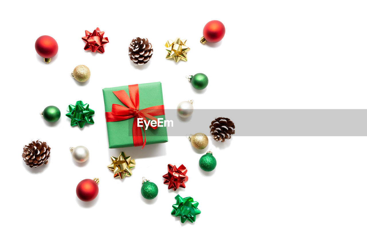 Directly above shot of christmas decorations with gift on white background