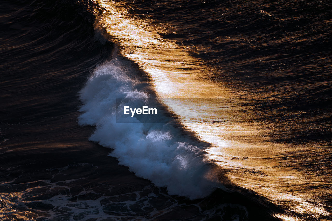 View of waves breaking on rocks