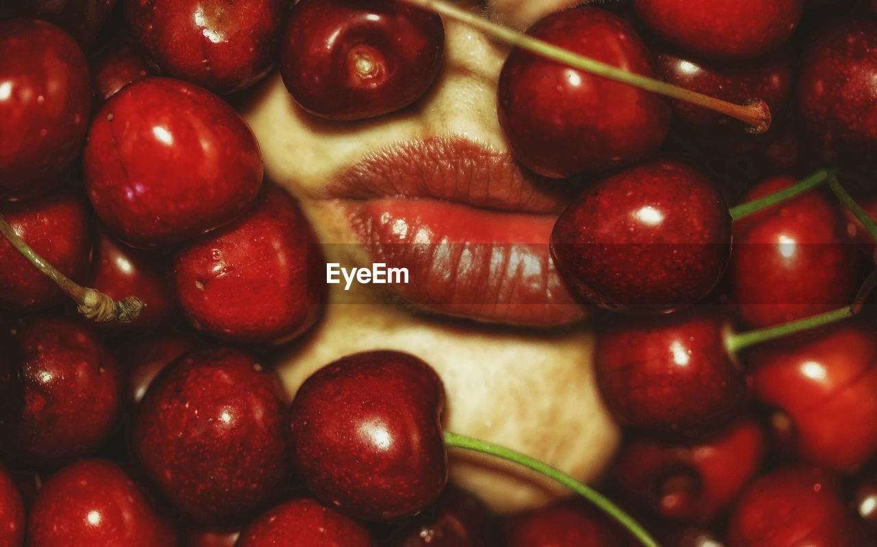 Full frame shot of cherry fruits with woman