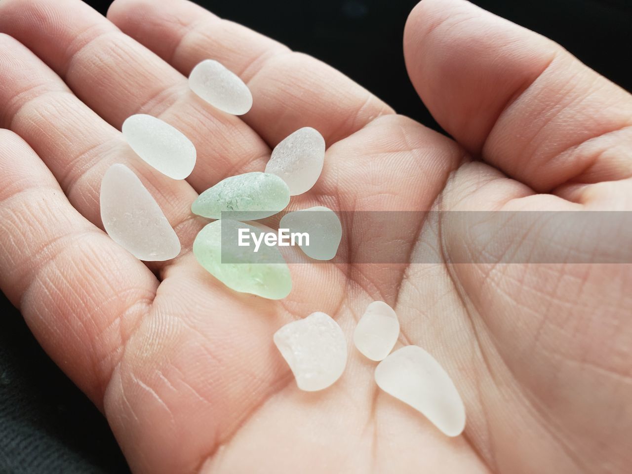 Cropped image of person holding crystals