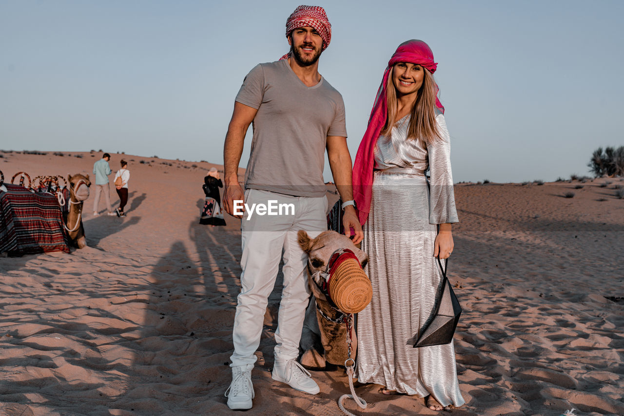 YOUNG COUPLE ON SAND