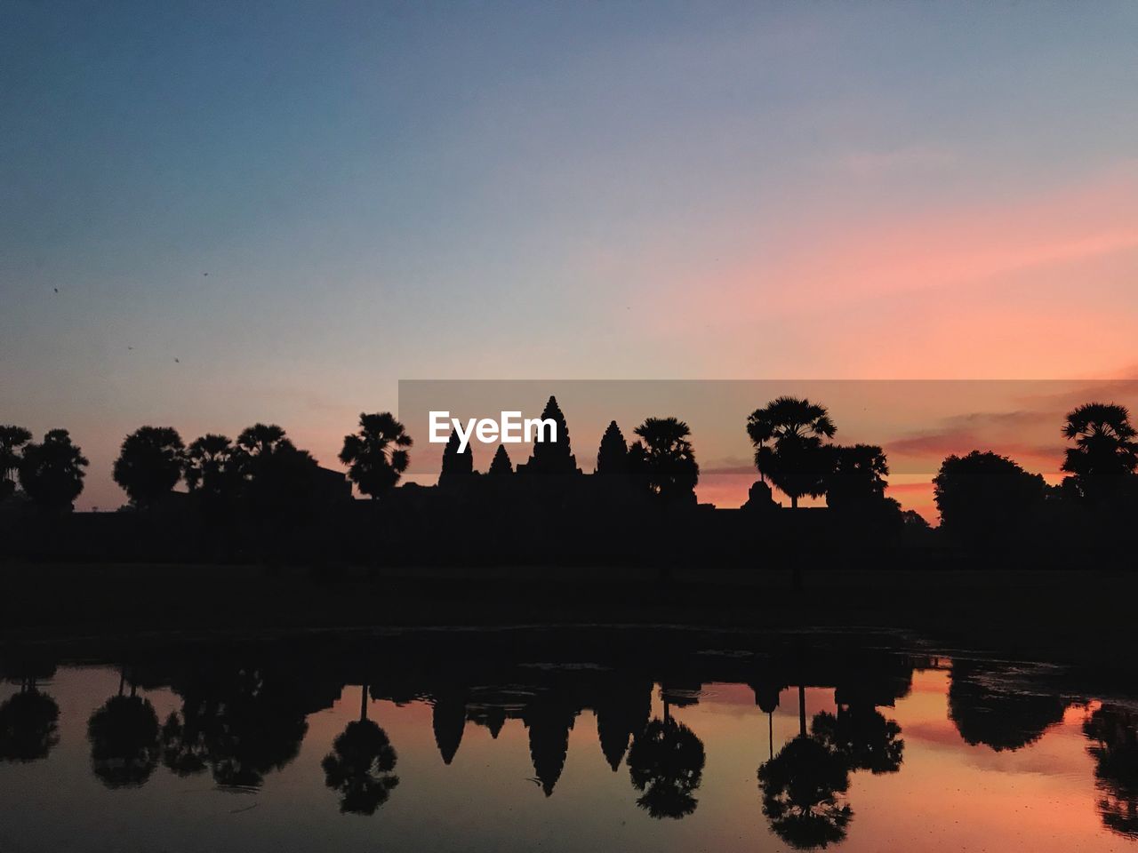 SILHOUETTE OF TEMPLE AGAINST SKY DURING SUNSET