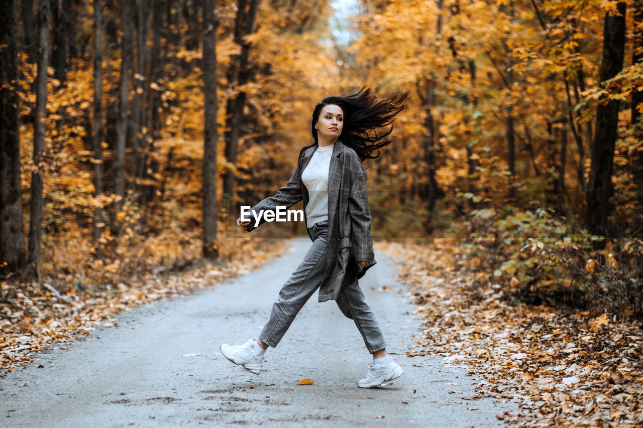 Autumn anxiety, mental health. happy brunette woman enjoy life in autumn forest