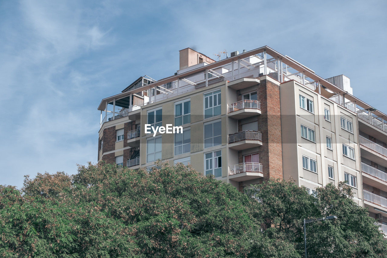 architecture, building exterior, built structure, building, residential area, estate, window, plant, sky, neighbourhood, residential district, tree, nature, house, tower block, city, no people, home, low angle view, apartment, home ownership, outdoors, facade, urban area, mansion, condominium, cloud, day, industry, growth, construction industry