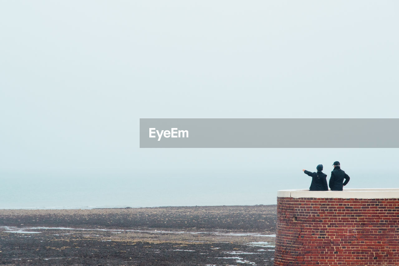 Rear view of couple looking at sea