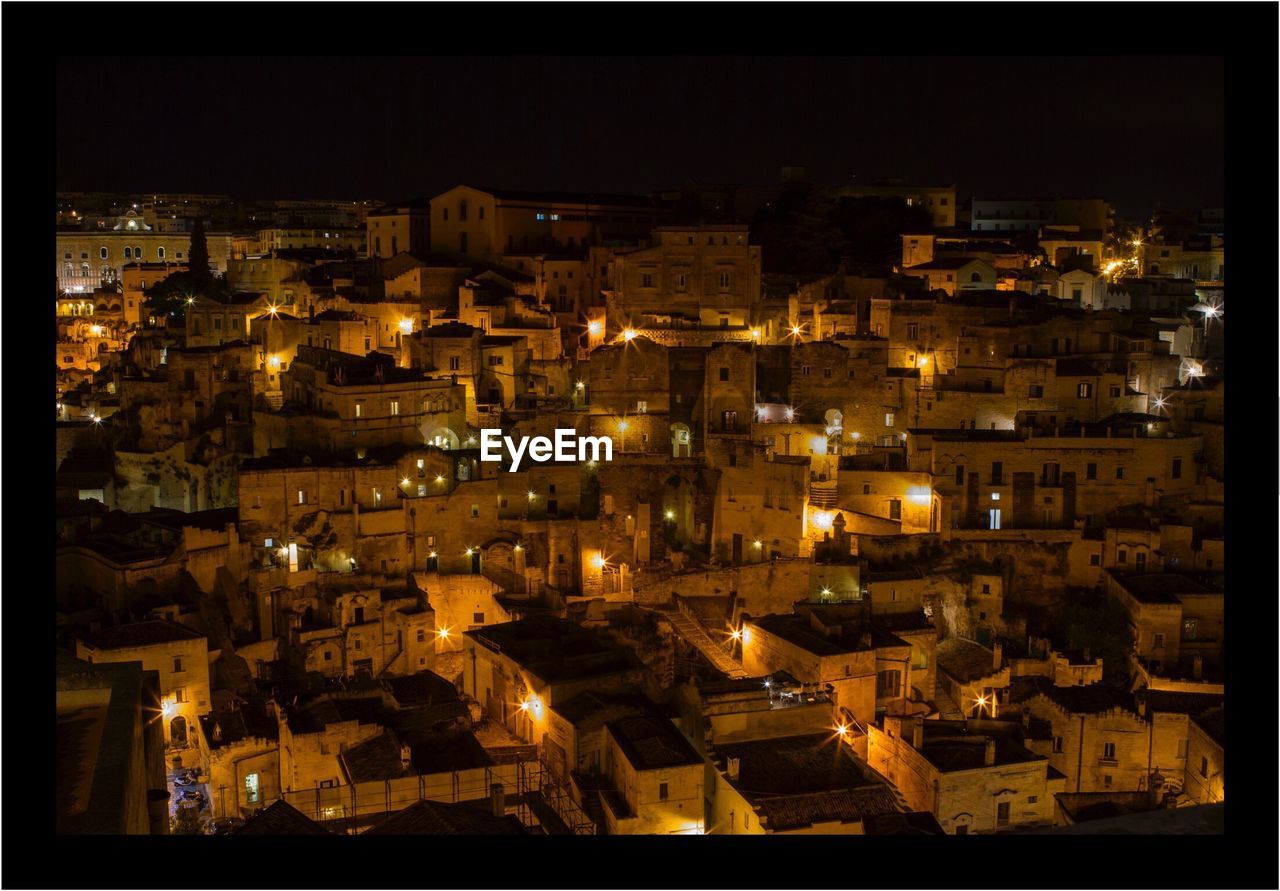 ILLUMINATED CITYSCAPE AGAINST SKY