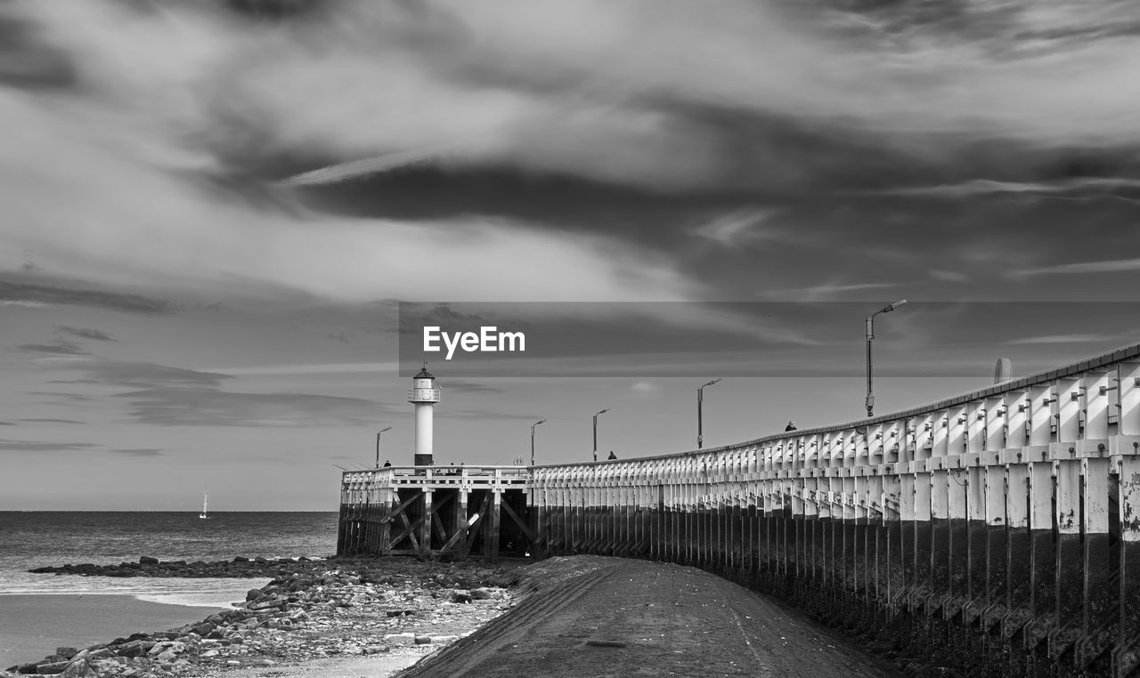 Scenic view of sea against sky. lighthouse along the sea. pier. belgium coast. 