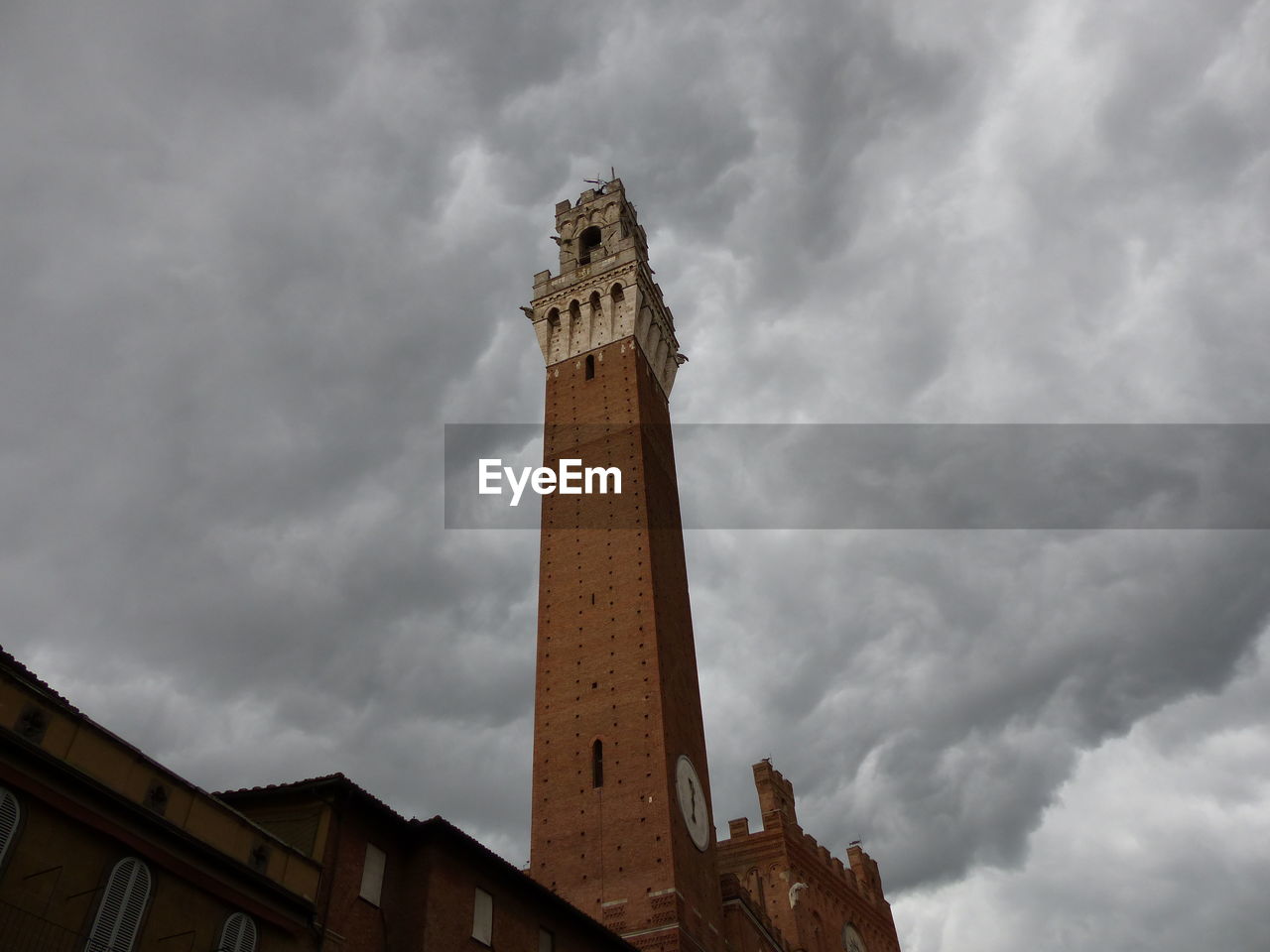 LOW ANGLE VIEW OF TOWER AGAINST CLOUDY SKY