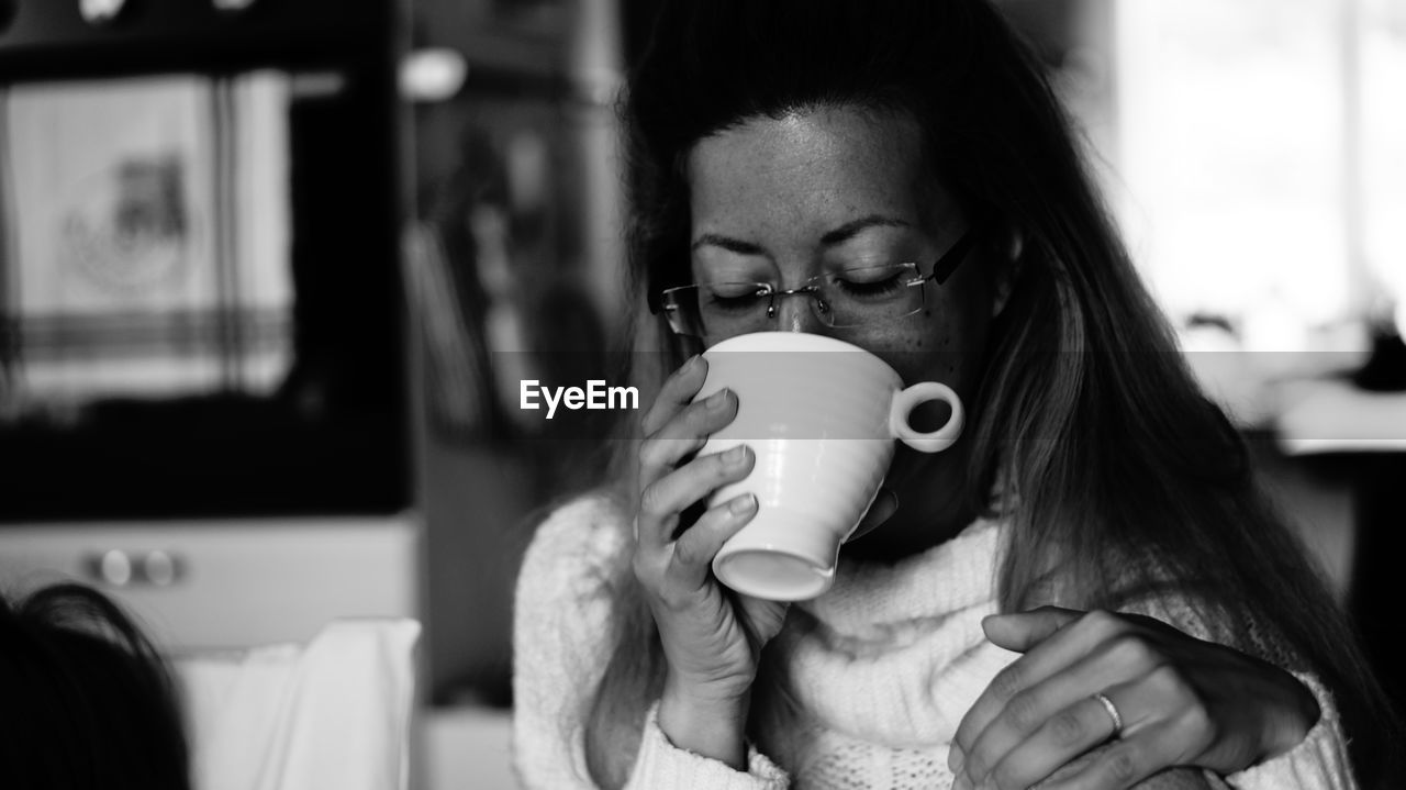 Woman drinking coffee at home