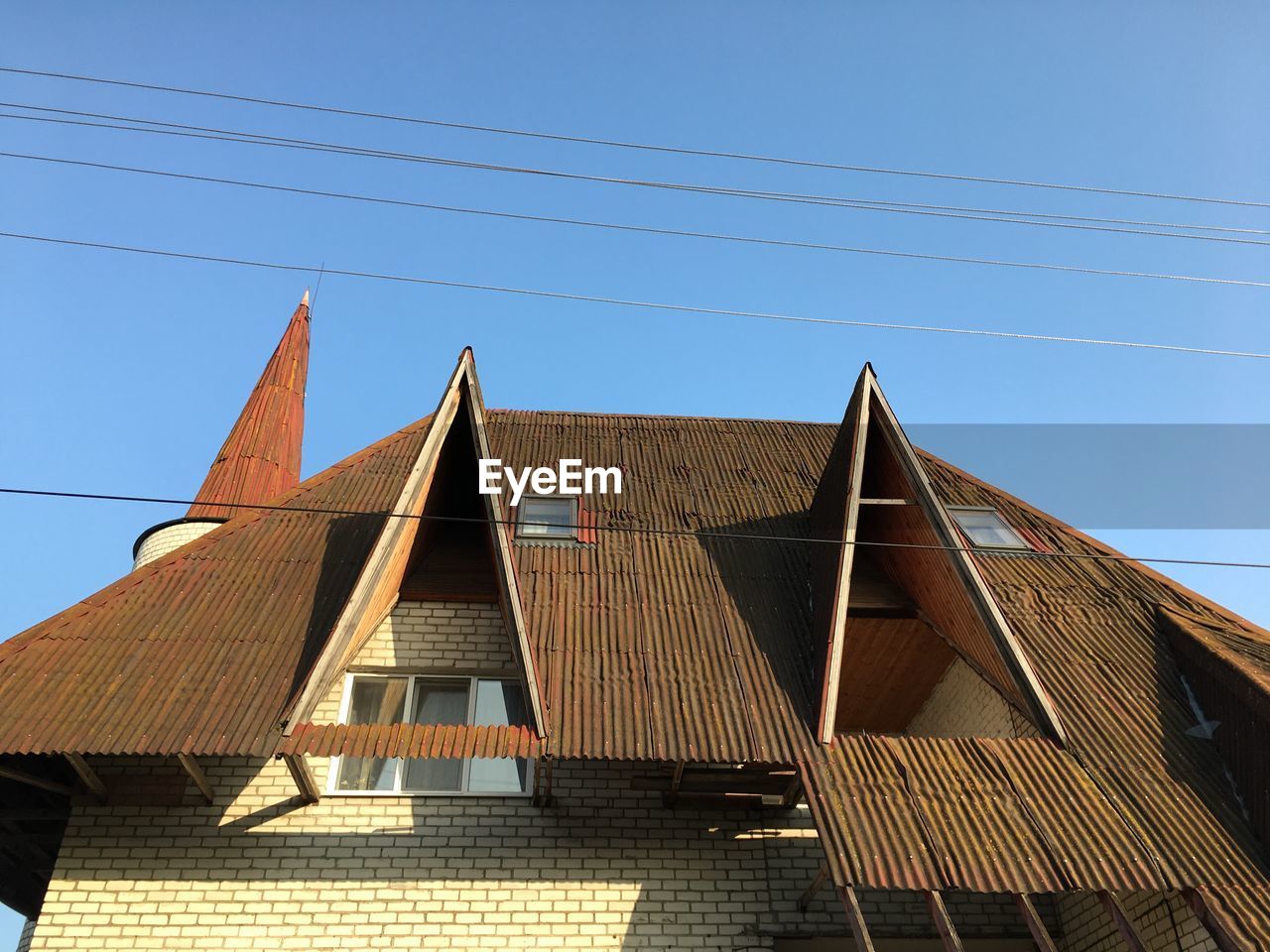 Low angle view of building against clear blue sky