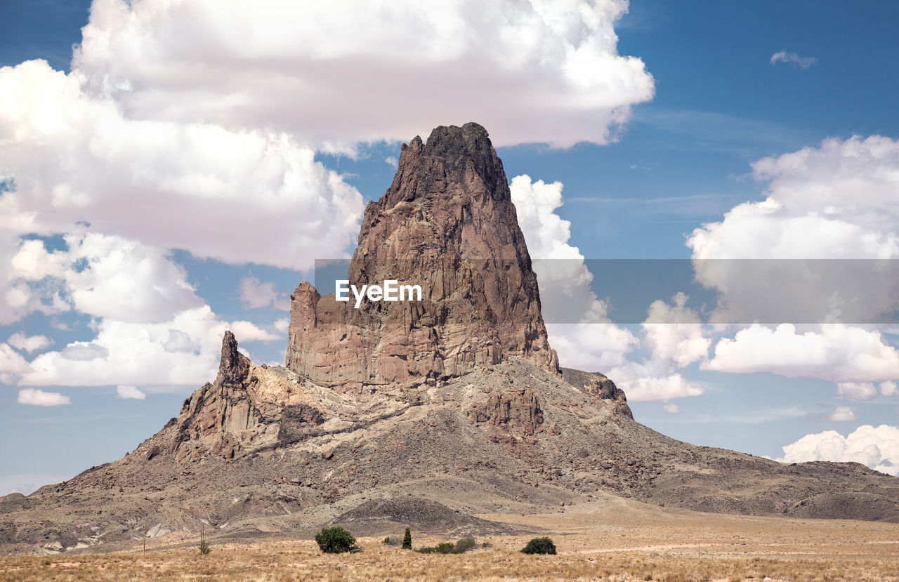 Scenic view of rock formation against cloudy sky