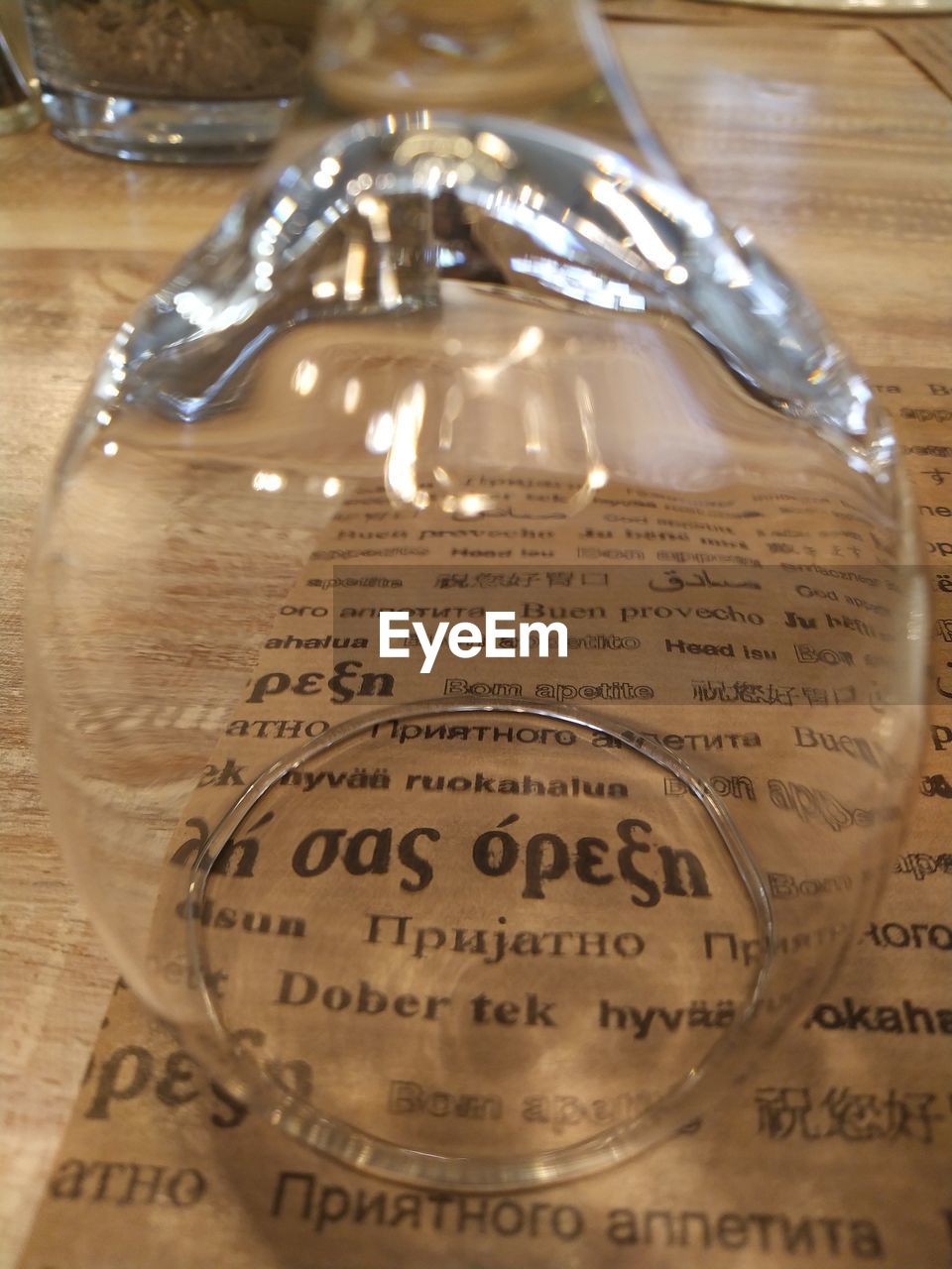 HIGH ANGLE VIEW OF GLASSES ON GLASS WITH TEXT