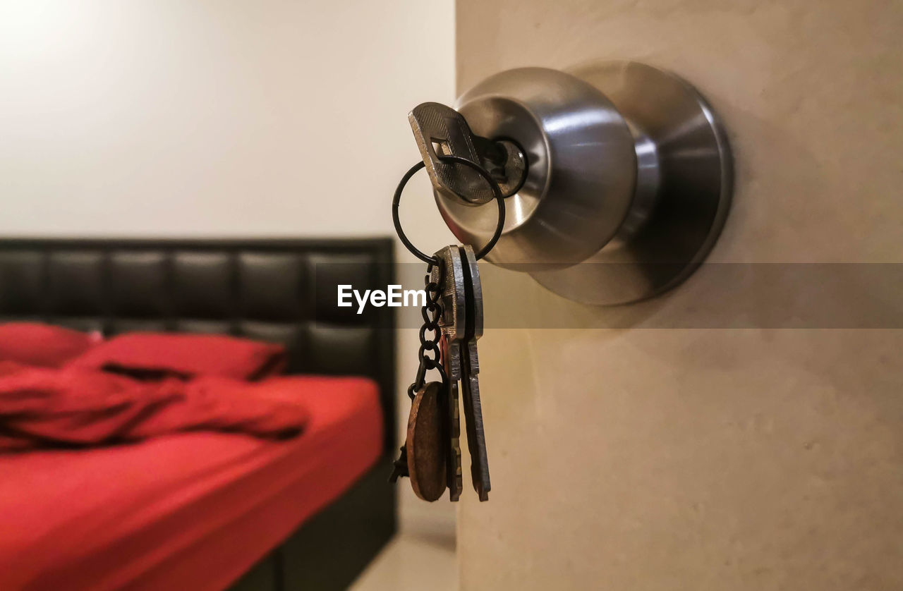 Close-up of keys on door knob of hotel room