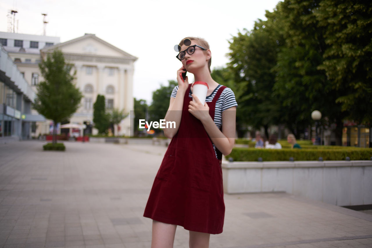 Young woman wearing sunglasses standing outdoors