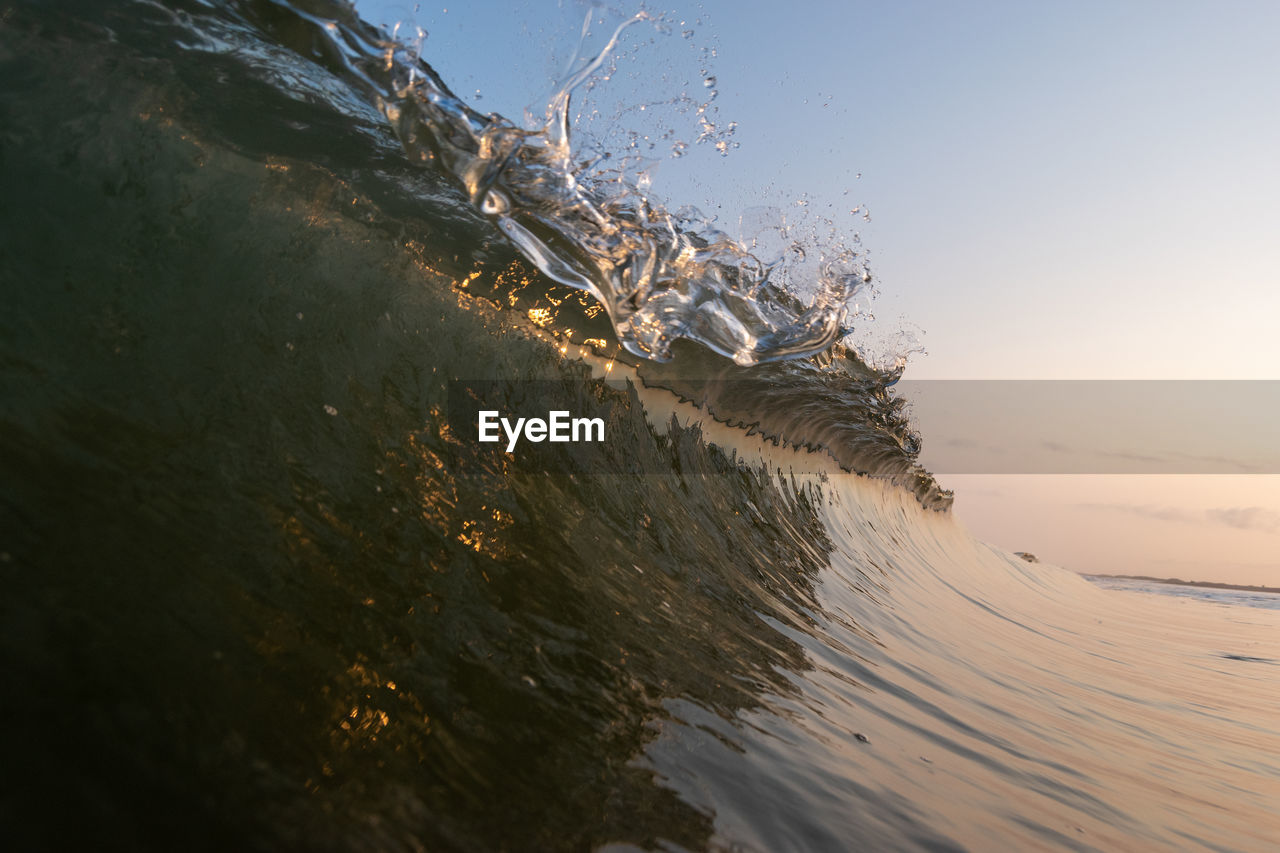 Close-up of sea waves splashing on beach