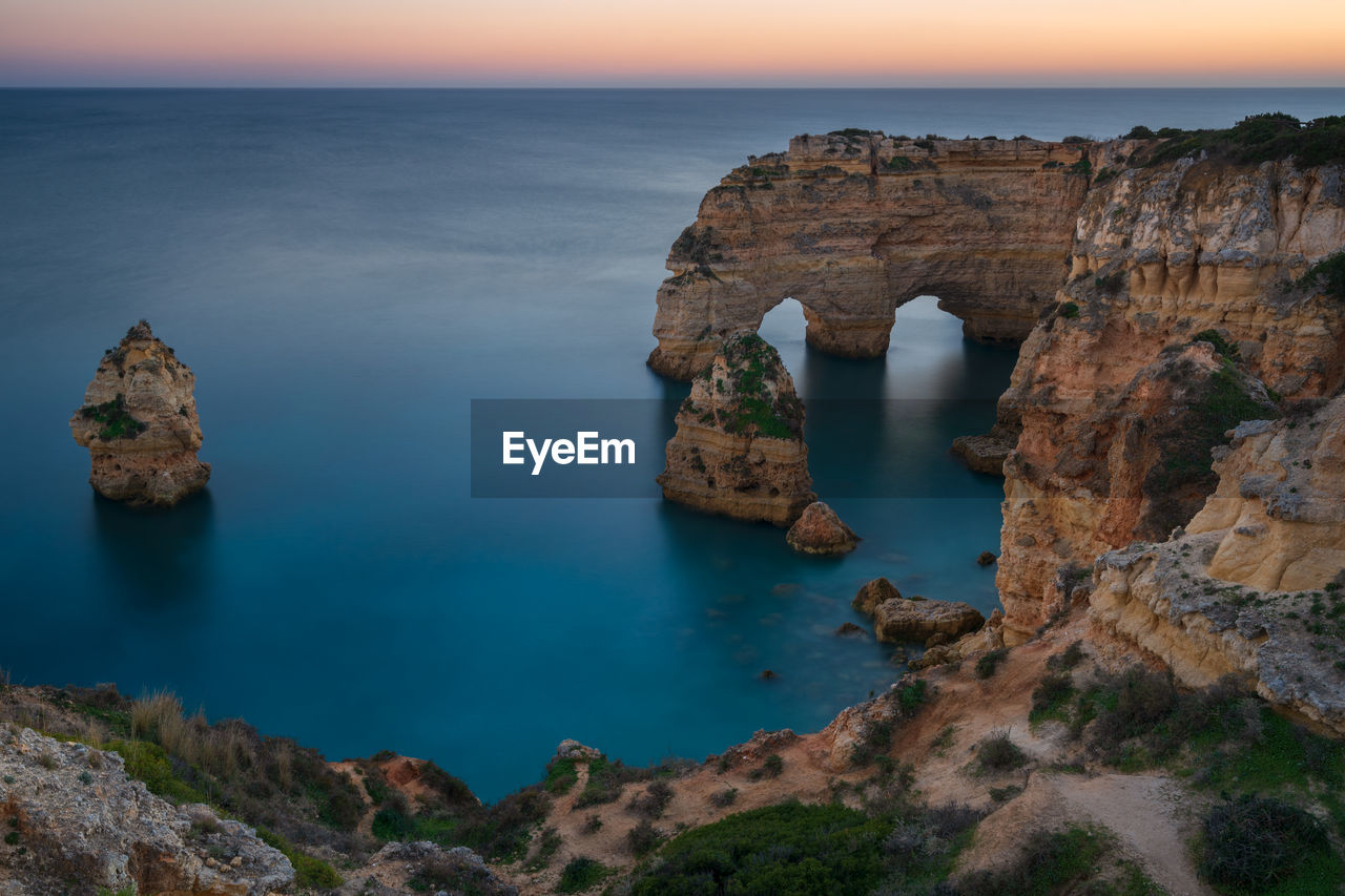 Natural arch cliffs of praia da marinha beach at sunset beautiful landscape in lagoa portugal