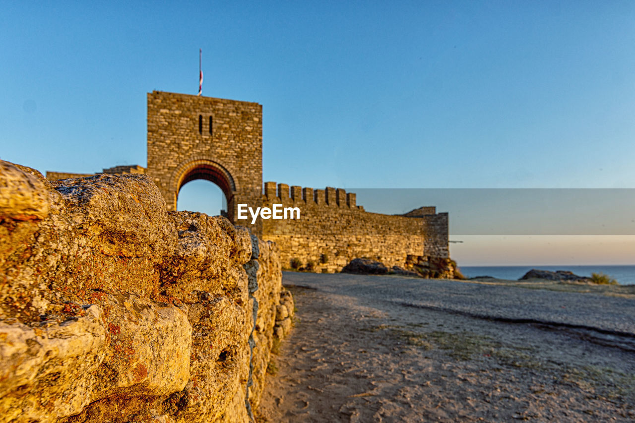 Historic building by sea against sky