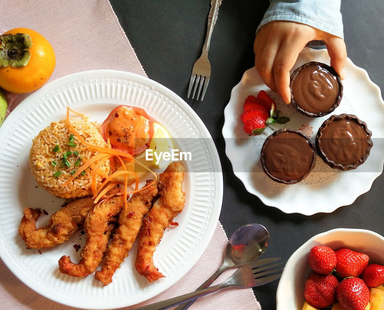 Cropped hand of person with food at table