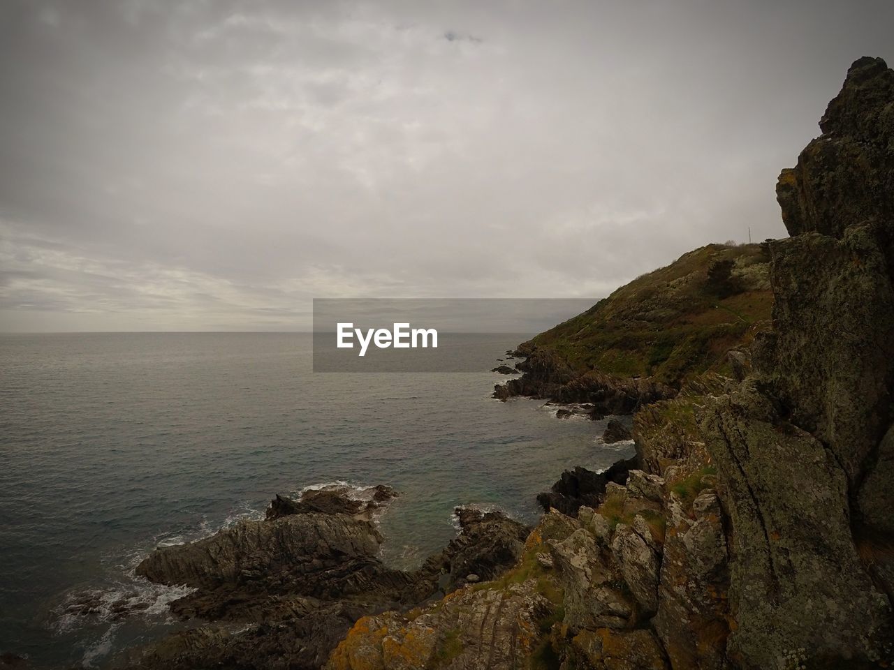 SCENIC VIEW OF SEA BY ROCKS AGAINST SKY