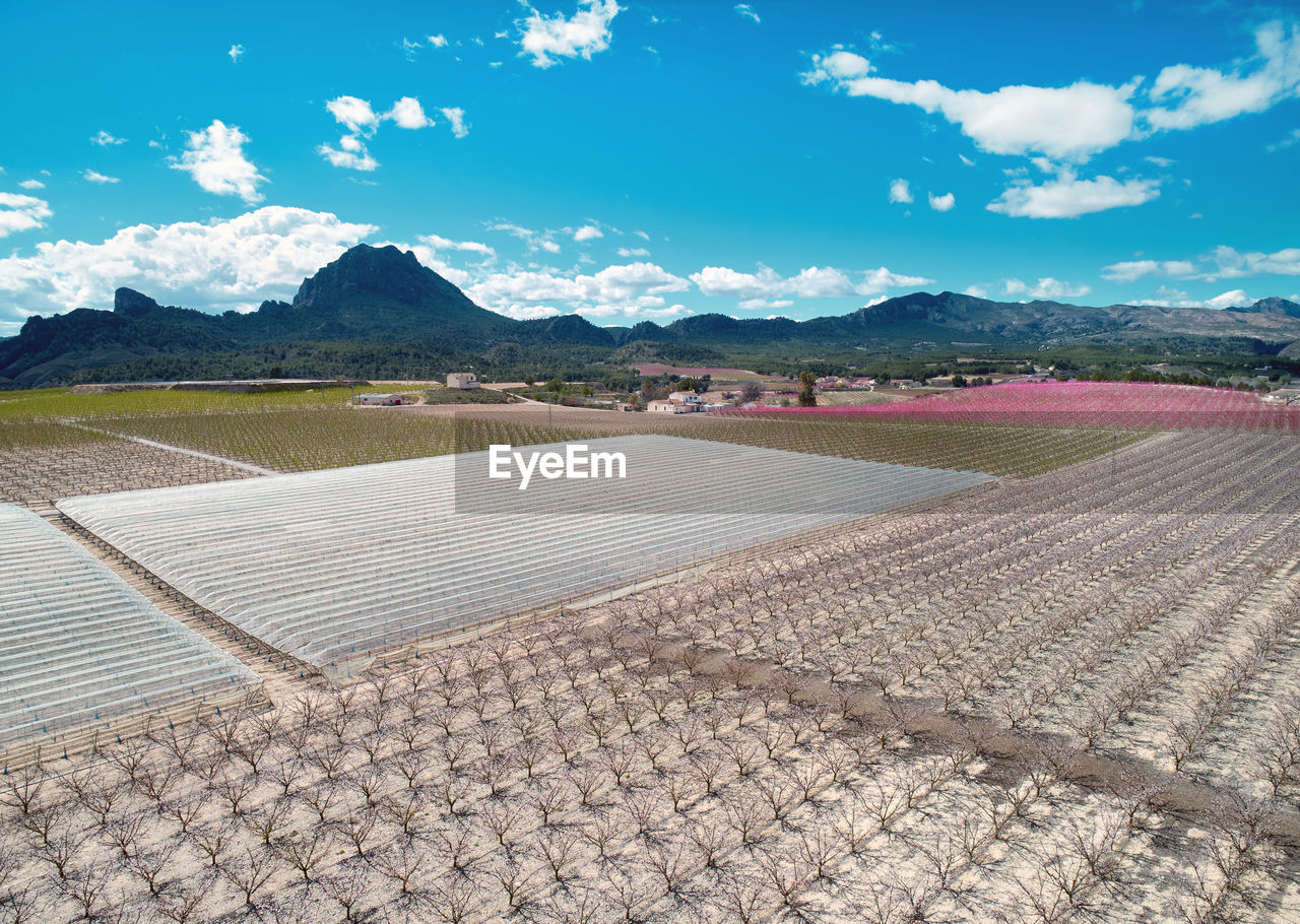 Aerial view of field against cloudy sky